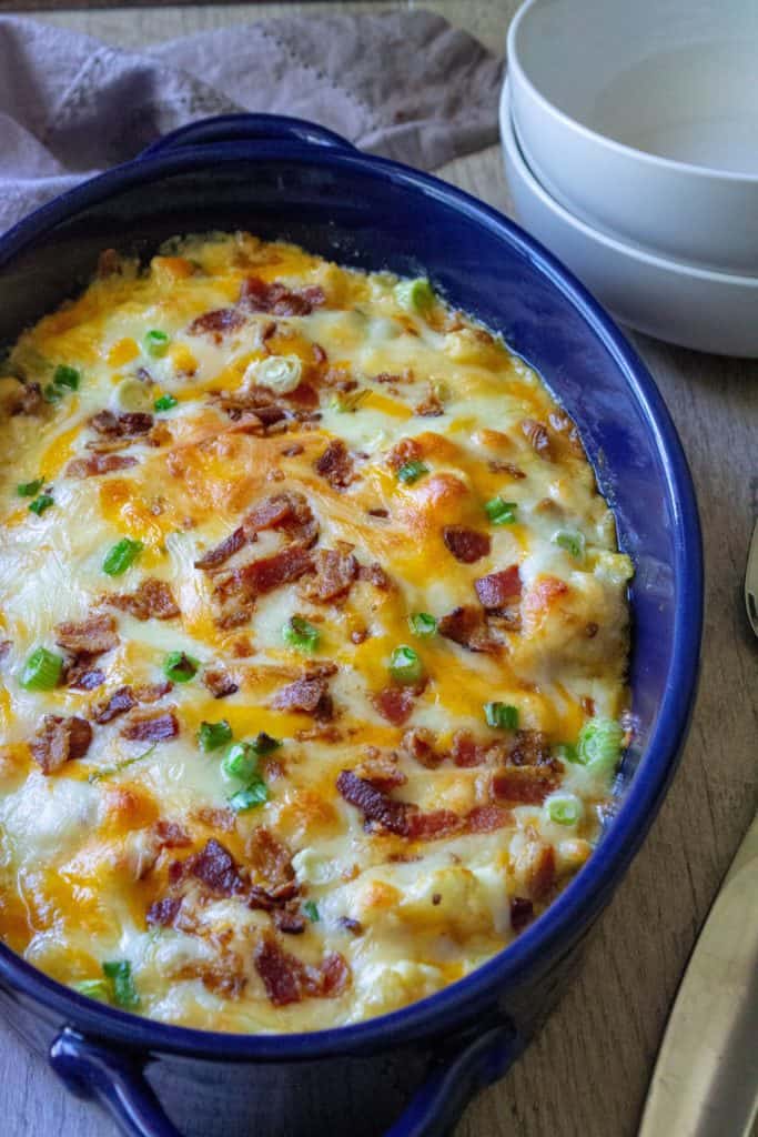 Loaded Cauliflower Casserole has all of the flavors of your favorite loaded baked potato casserole without all of the carbs.  Made with fresh cauliflower florets, sharp cheddar cheese, crispy bacon and green onions, this Loaded Cauliflower Casserole is the perfect keto low-carb side dish. | A Wicked Whisk