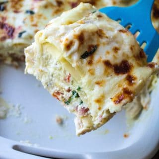 White Chicken Lasagna is rich with sharp cheeses, a creamy bechamel sauce and packed with basil, sun-dried tomatoes and tons of garlic flavor. Comfort food at it's best, this White Chicken Lasagna is hearty, delicious and sure to be your families new favorite chicken recipe.