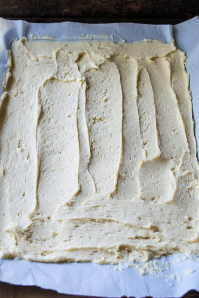 Frosted Sugar Cookie Bars on a sheet pan