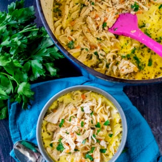 classic chicken noodle soup in a bowl with a spoon
