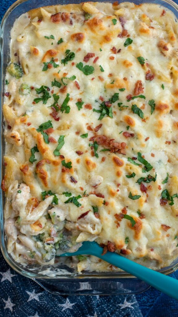 This baked Chicken Broccoli Alfredo Pasta is a hearty upgrade on your favorite fettuccini Alfredo recipe. Made with shredded chicken, crispy bacon, broccoli, homemade Alfredo sauce and tons of cheese, this cheesy chicken Alfredo casserole is an ultimate comfort food favorite!