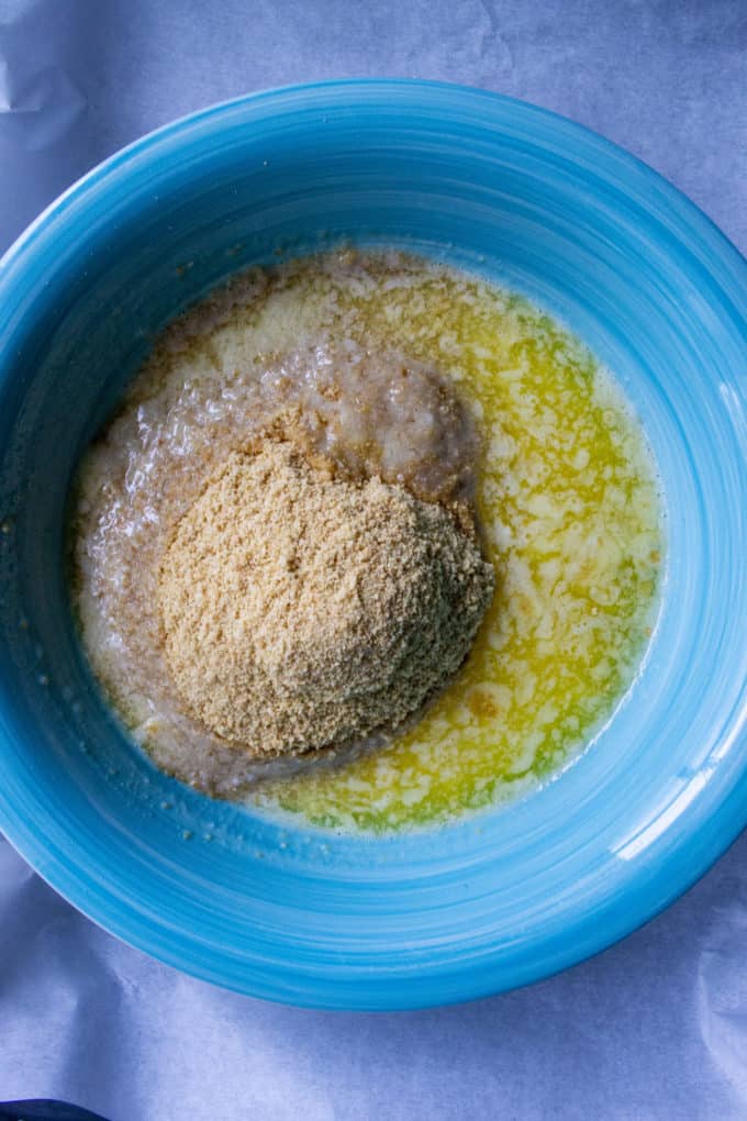 butter and graham cracker crumbs in a bowl