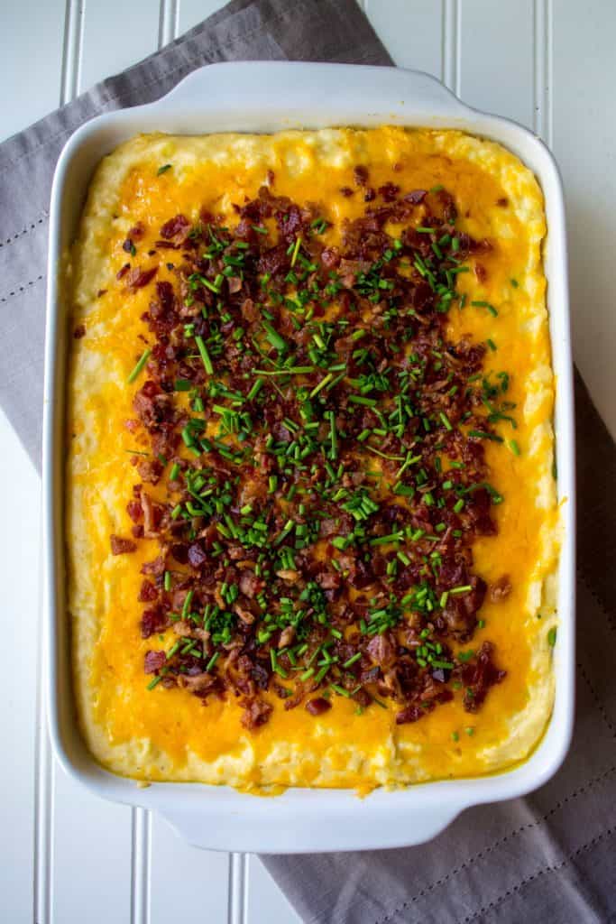 Loaded Mashed Potato Casserole | Loaded Mashed Potato Casserole is an upgraded version of your favorite potato recipe. Smothered in melted cheese and BACON, this is the best side dish ever! | Pack Momma | https://www.awickedwhisk.com