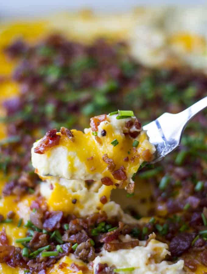 Loaded Mashed Potato Casserole | Loaded Mashed Potato Casserole is an upgraded version of your favorite potato recipe. Smothered in melted cheese and BACON, this is the best side dish ever! | Pack Momma | https://www.awickedwhisk.com