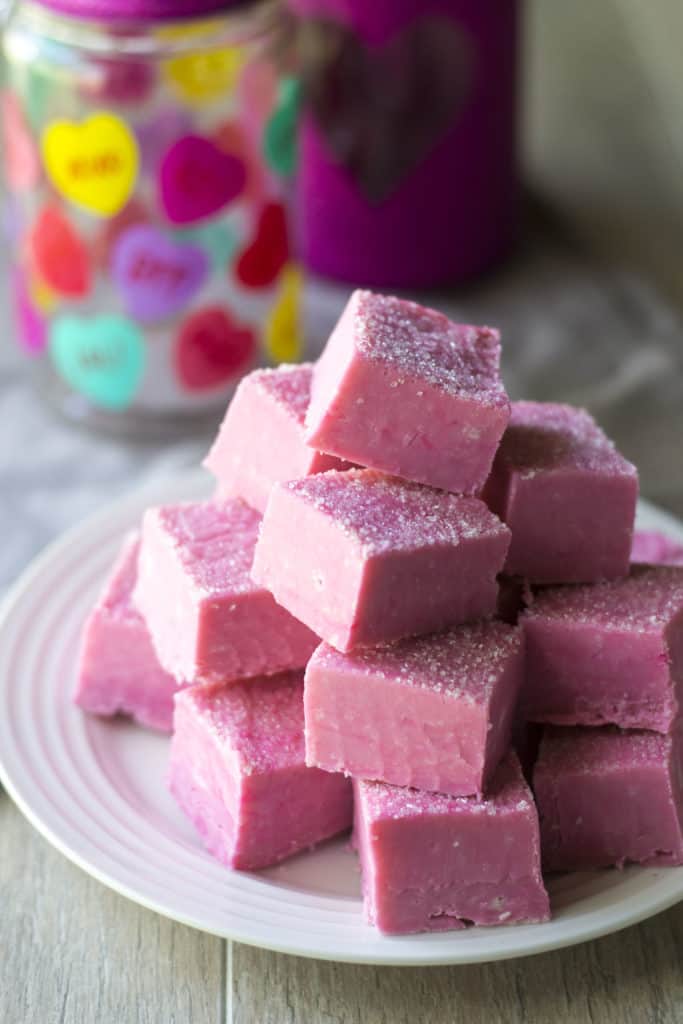 Pink White Chocolate Fudge stacked up on a plate