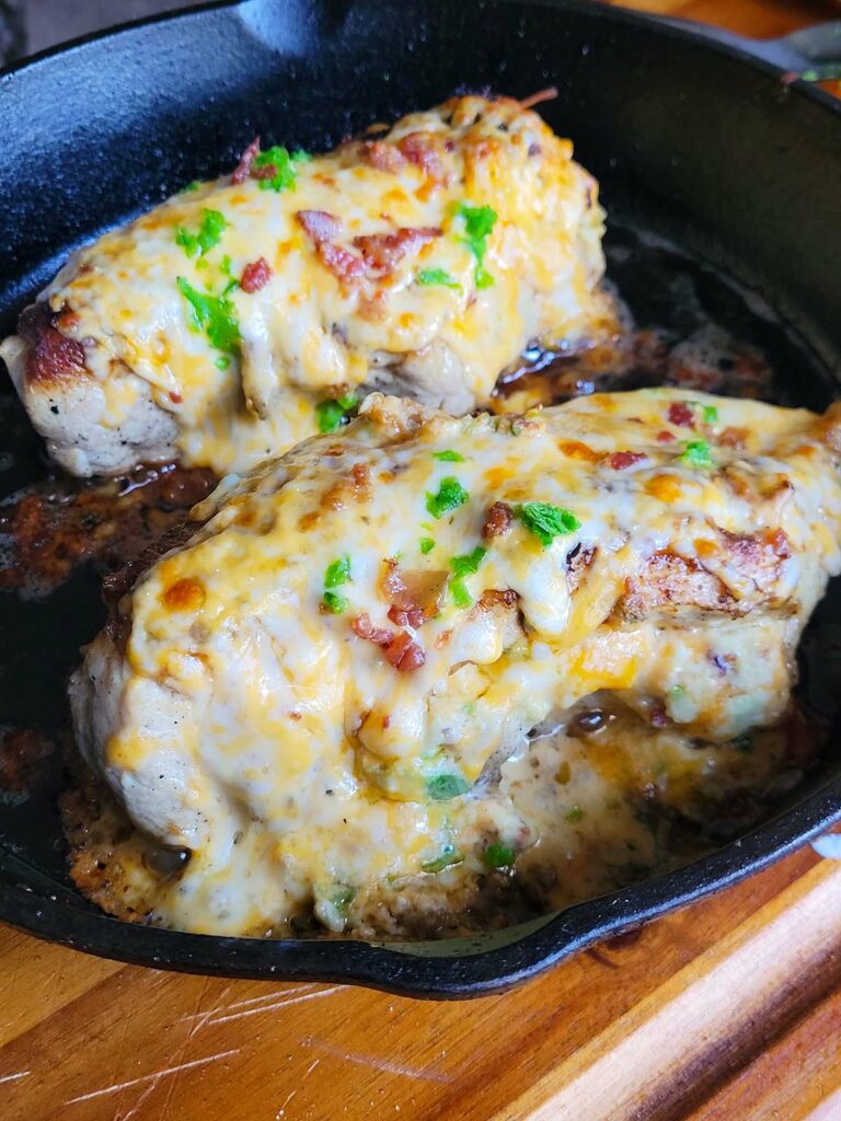 cheesy jalapeno stuffed chicken breast in a cast iron pan