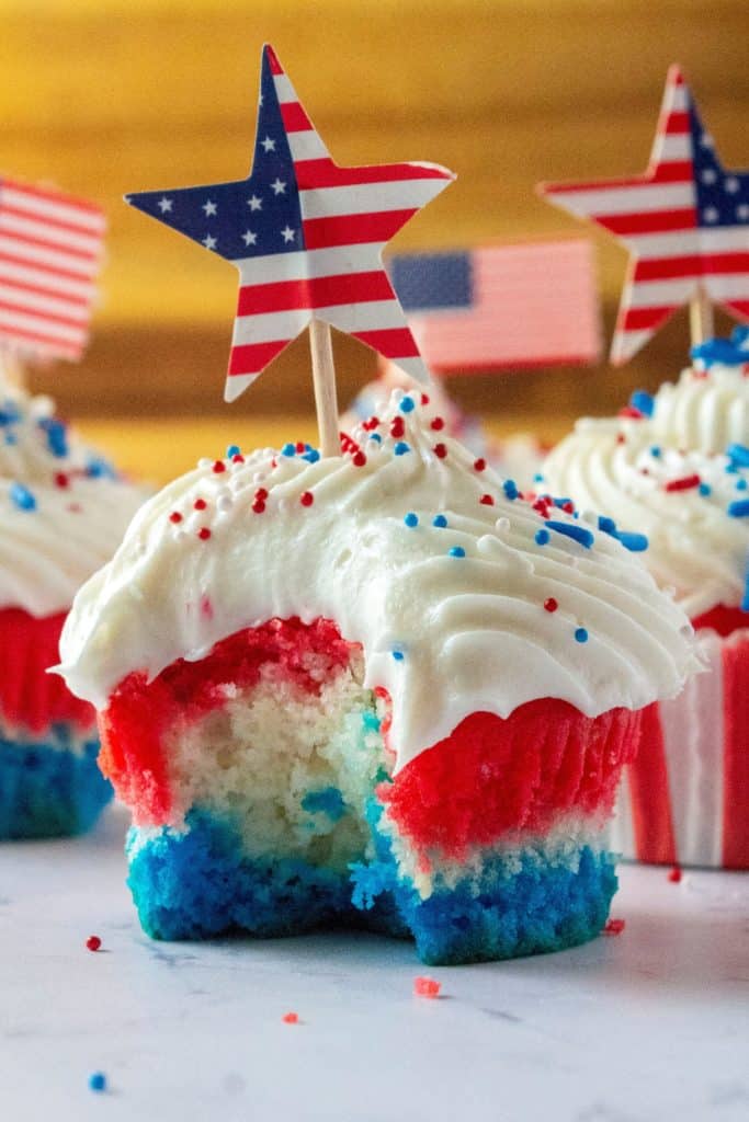 Red White and Blue Patriotic Cupcakes are the perfect Fourth of July Cupcakes to show off your American pride. Red, white and blue layered cupcakes topped with homemade buttercream frosting, these Red White and Blue Patriotic Cupcakes will be the star of every Fourth of July dessert table.