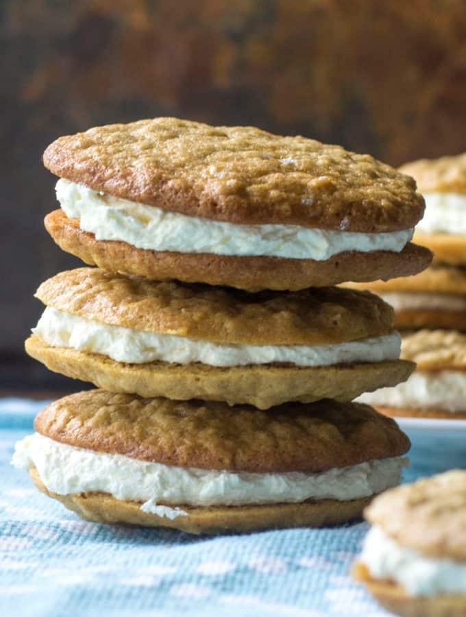 Homemade Oatmeal Cream Pies are the very best grown up version of your favorite childhood snack.  Reminiscent of Little Debbie Oatmeal Creme Pies, these Homemade Oatmeal Cream Pies are soft, chewy and perfectly filled with sweet marshmallow creme filling in the middle. .. stacked