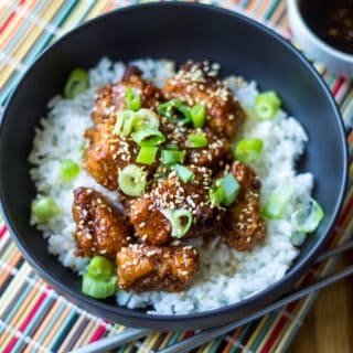 Sticky Chicken Rice Bowl is the perfect combination of tender rice and baked chicken bites covered in a thick sticky sauce and it is sure to be your new favorite sweet and spicy chicken recipe. A quick and easy Asian chicken recipe, this Sticy Chicken Rice Bowl is ready to serve up in just 30 minutes!