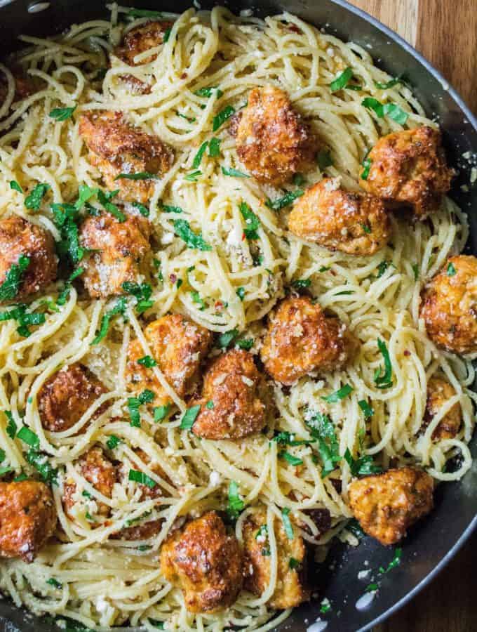 Garlic Parmesan Spaghetti with Chicken Meatballs is an easy spaghetti recipe with tons of fresh garlic, Pamesan cheese and tender baked chicken meatballs. 