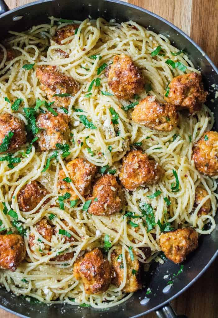 Parmesan Garlic Spaghetti with Chicken Meatballs is an easy spaghetti recipe with tons of fresh garlic, Pamesan cheese and tender baked chicken meatballs. 