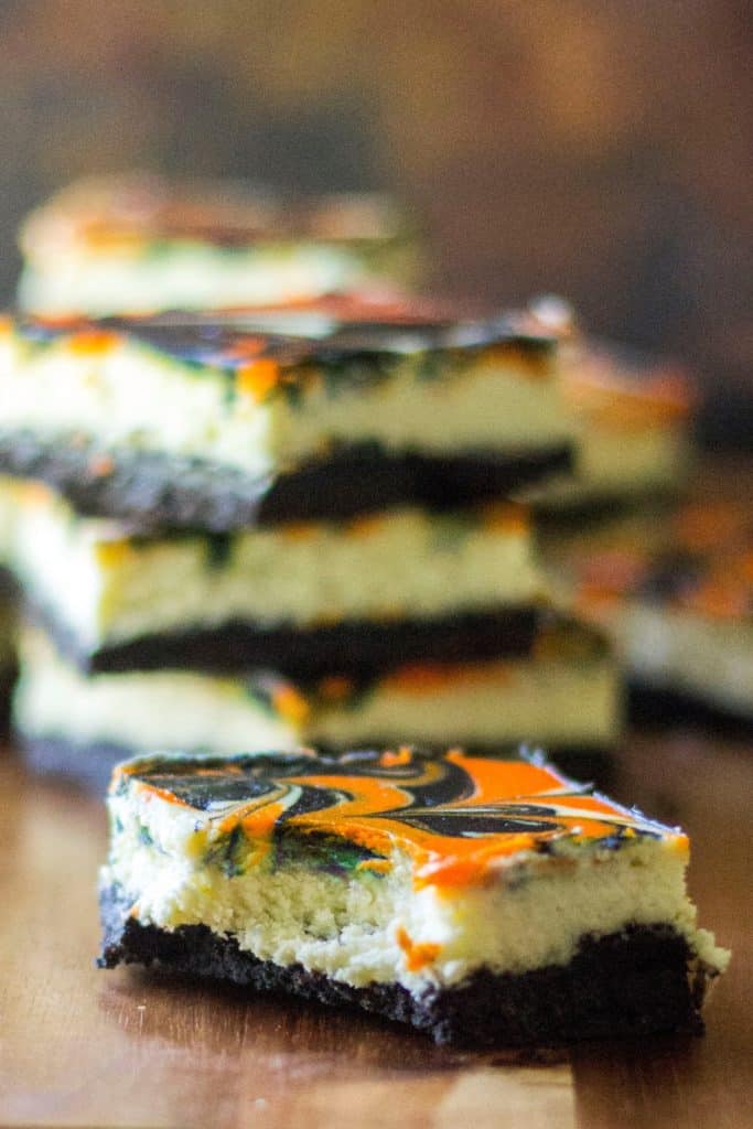 Halloween Cheesecake Bars are the perfect Halloween dessert to show off your spooky spirit. Creamy cheesecake with a cookie crust, these orange and black Halloween Cheesecake Bars are the perfect easy dessert to celebrate Halloween.