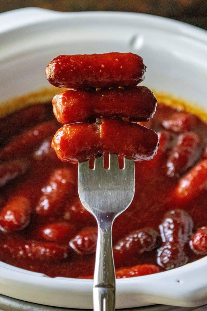 Spicy BBQ Little Smokies are easy appetizers perfect for Game Day parties, holiday get togethers and potlucks. Made in your slow cooker, these crockpot Spicy BBQ Little Smokies are sweet, spicy and the hit of every party!