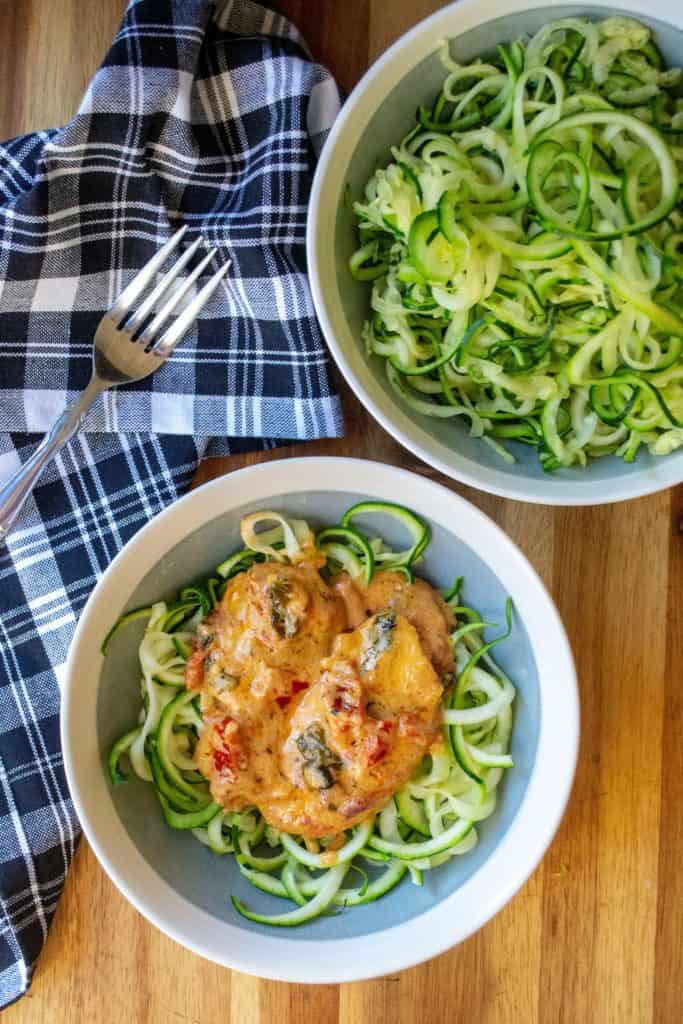 Creamy Tuscan Chicken is tender skillet chicken in a creamy cheese sauce full of sun dried tomatoes, fresh basil and served over a bed of zoodles . Soon to be one of your favorite one pan meals, this Creamy Tuscan Chicken is a low carb keto friendly recipe ready in just 30 minutes!