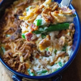 Green Bean Casserole with Bacon is everyone's favorite classic holiday side dish kicked up with tons of mouthwatering flavor. Made with fresh green beans, crispy bacon, topped with French fried onions and melted cheese and no condensed soup, this Green Bean Casserole with Bacon is the perfect easy side dish any night of the week. 