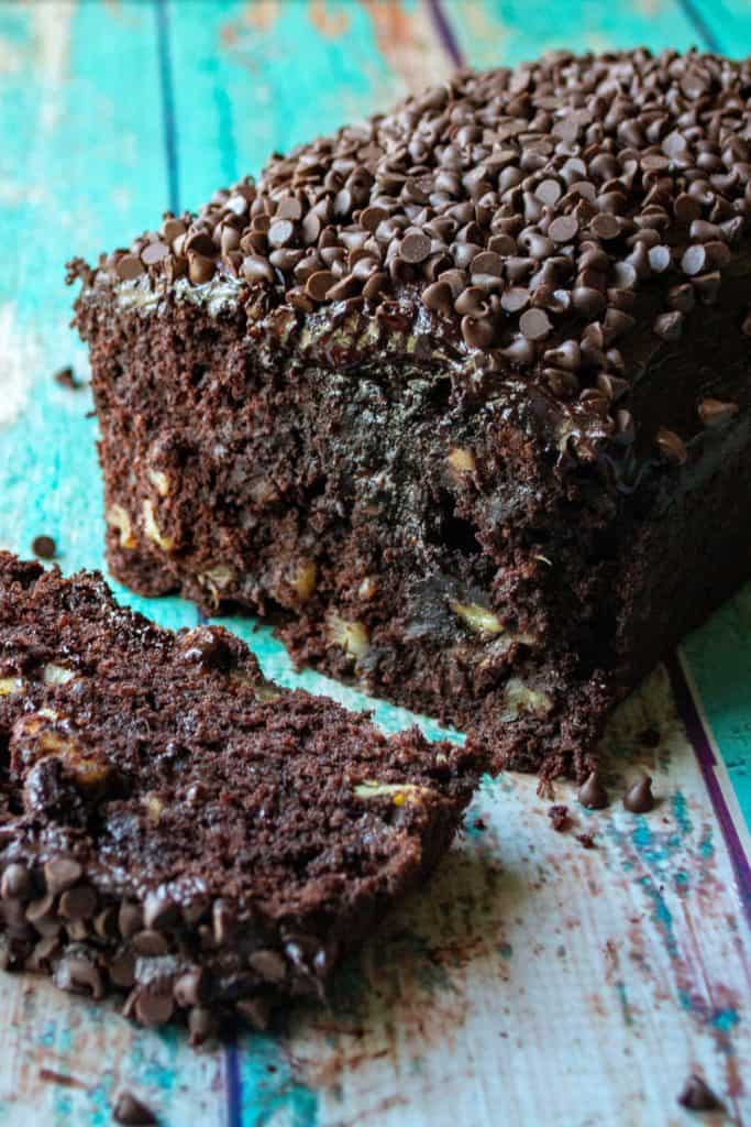Triple Chocolate Banana Bread is super moist banana bread with TRIPLE chocolate throughout. Super easy chocolate banana bread speckled with mini chocolate chips and then slathered in homemade chocolate buttercream frosting makes this Triple Chocolate Banana Bread a chocolate lovers dream!  | A Wicked Whisk