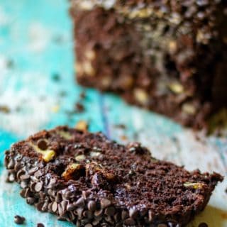 Triple Chocolate Banana Bread is super moist banana bread with TRIPLE chocolate throughout. Super easy chocolate banana bread speckled with mini chocolate chips and then slathered in homemade chocolate buttercream frosting makes this Triple Chocolate Banana Bread a chocolate lovers dream! | A Wicked Whisk