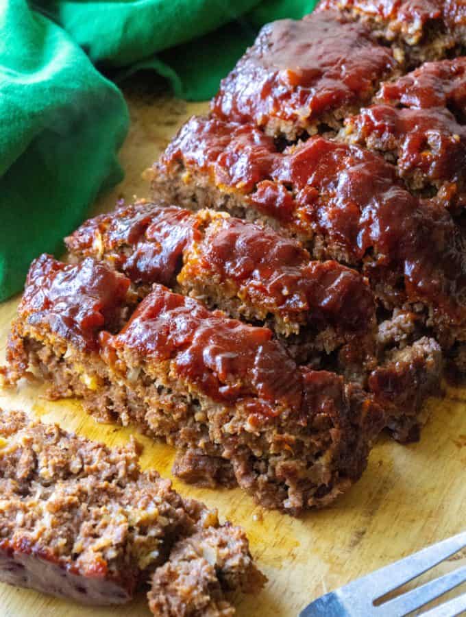 Better Than Your Momma's Classic Meatloaf takes mom's favorite meatloaf recipe from your childhood and (ahem!) serves it up even better.  Moist, flavorful, made with many of the classic ingredients and a few surprizes, Better Than Your Momma's Classic Meatloaf delivers you the hearty rich comfort food you have been craving. | A Wicked Whisk