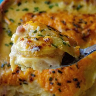 Cheesy Scalloped Potatoes and Ham is the ultimate in cheesy potato comfort food recipe.  Made with tons of creamy cheese, sliced potatoes and chunks of ham, this Cheesy Scalloped Potatoes and Ham recipe is the perfect make ahead dinner or the best every day meal. | A Wicked Whisk