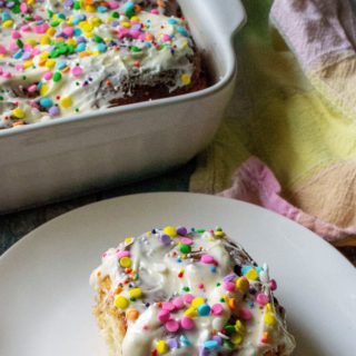 Funfetti Cinnamon Rolls made with rainbow sprinkles, slathered in homemade cream cheese frosting and topped with confetti sprinkles makes this classic cinnamon rolls recipe a fun and tasty treat. | A Wicked Whisk