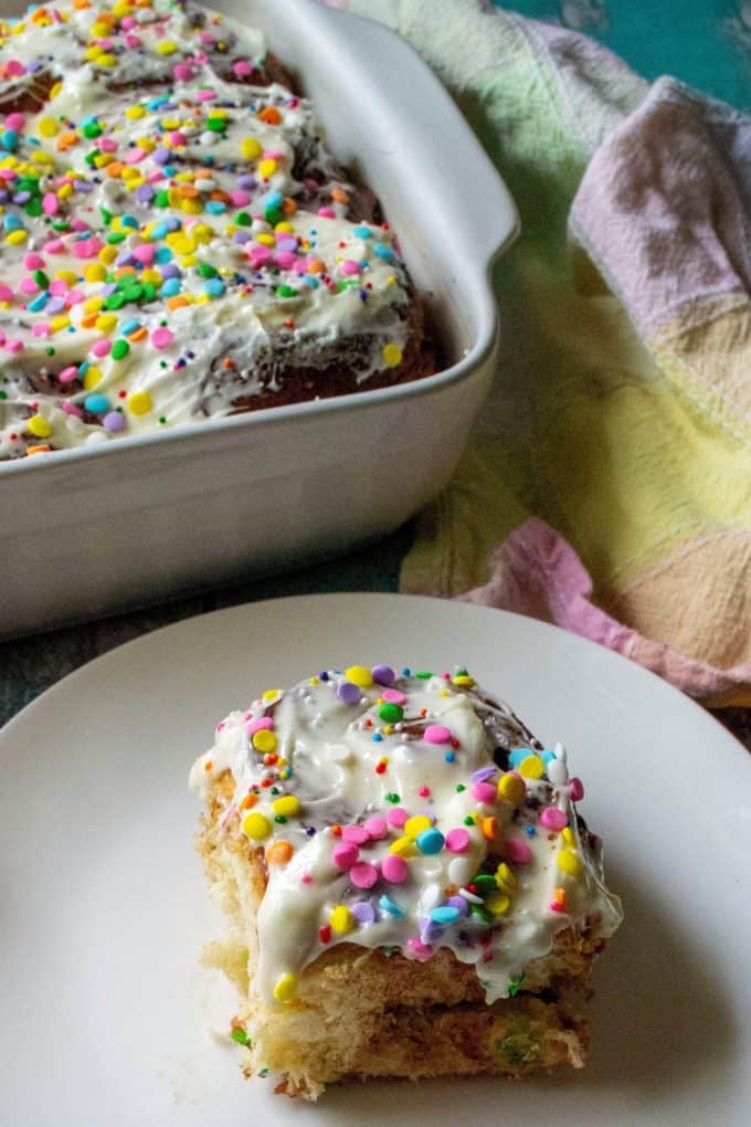 Funfetti Cinnamon Rolls made with rainbow sprinkles, slathered in homemade cream cheese frosting and topped with confetti sprinkles makes this classic cinnamon rolls recipe a fun and tasty treat. | A Wicked Whisk