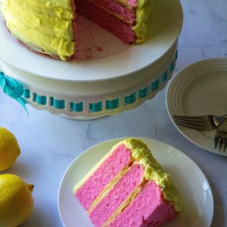 Pink Lemonade Cake is moist, tangy and the perfect summertime treat! Made from scratch with no frozen concentrate, this Pink Lemonade Cake is covered in lemon buttercream frosting and celebrates your favorite summertime drink with its bright pink cake color. | A Wicked Whisk