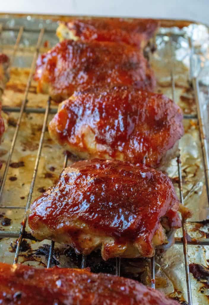 Easy Oven Baked BBQ Chicken is your favorite juicy, finger-licking BBQ chicken made easy in your very own kitchen.  Crispy skin, oven baked to perfection and slathered in your favorite BBQ sauce, this Easy Oven Baked BBQ Chicken is the perfect chicken dinner recipe any night of the week. | A Wicked Whisk