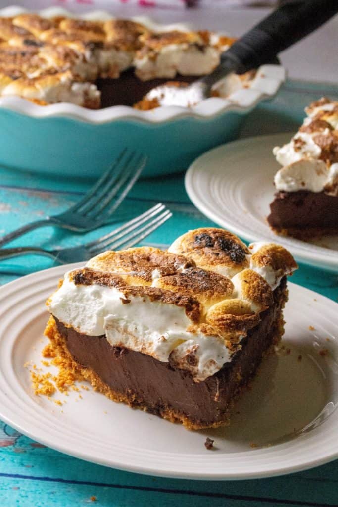 S'mores Pie is toasted marshmallows over a creamy chocolate ganache filling and a thick graham cracker crumb crust. Inspired by your favorite campfire dessert, this S'mores Pie is the decadent, grown-up version of that best-loved summertime treat.