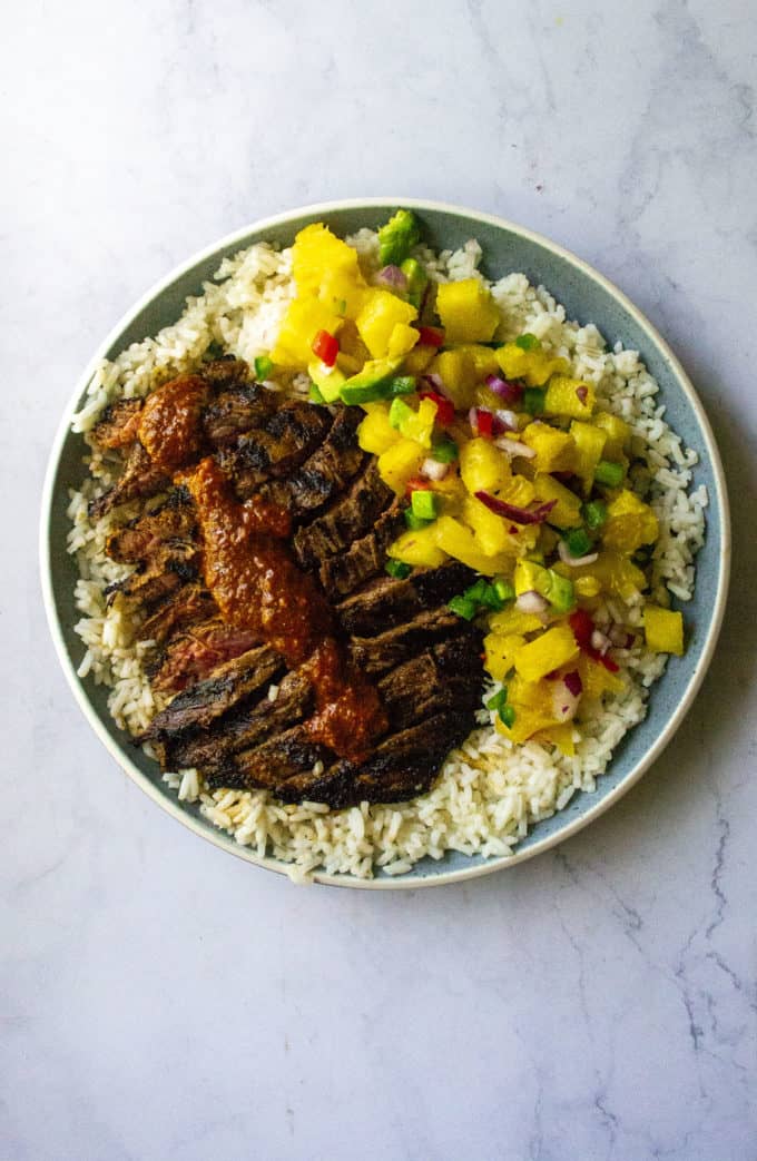 Mexican flank steak on a plate with salsa