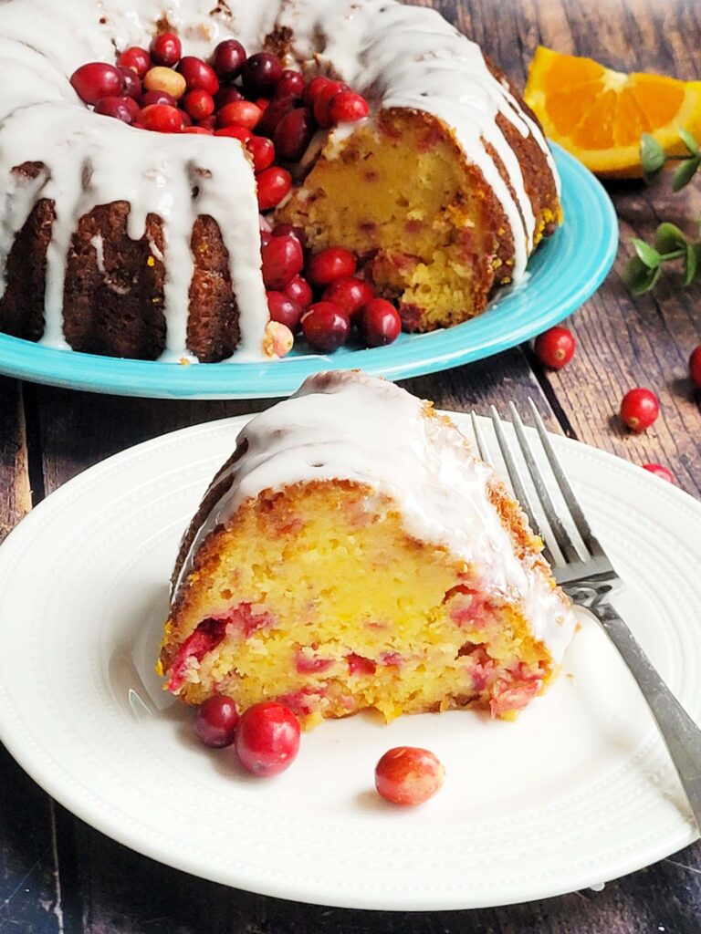 Moist and flavorful, this Cranberry Orange Bundt Cake combines tart cranberries, bright citrus zest, and rich buttery orange juice cake. Inspired by the Orange Juice Cake, this holiday bundt cake is the perfect addition to any holiday party or weekend brunch!