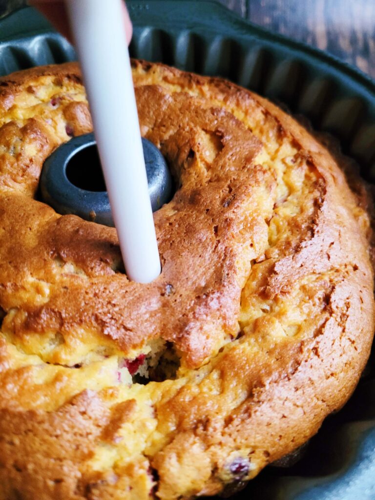 poking holes in bottom of cake for orange butter to be added