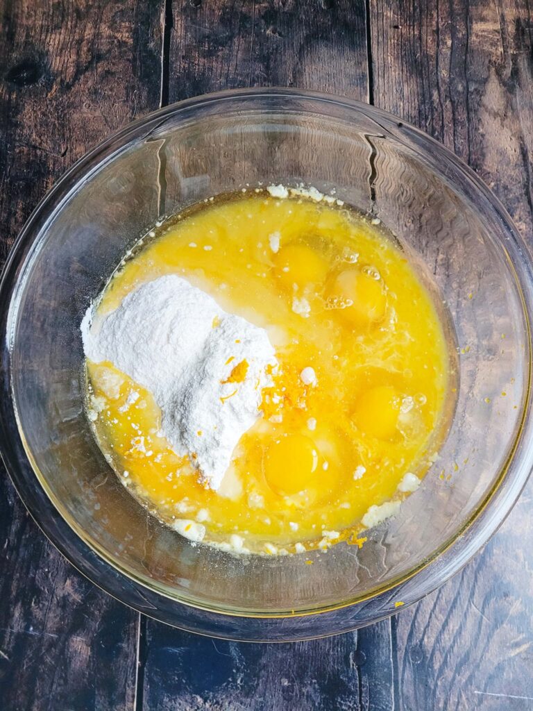 ingredients to make orange cake mix cake in a bowl