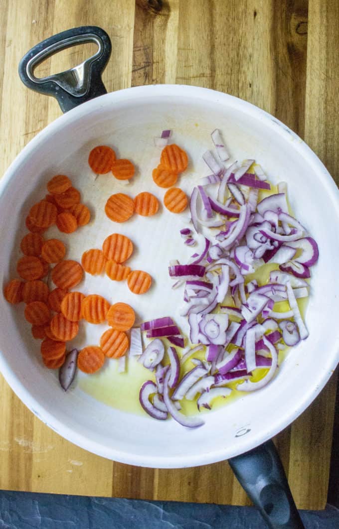 onions and carrots in a skillet
