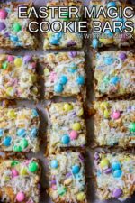 Easter Magic Cookie Bars are a buttery graham cracker crust layered with white chocolate chips, coconut flakes, walnuts and butterscotch chips then topped off with a sprinkling of pastel colored Easter M&Ms. This perfectly oooey gooey Easter Magic Bar is the ultimate easy holiday dessert!