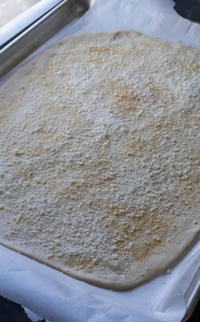 pizza dough for stromboli stretched on a pan
