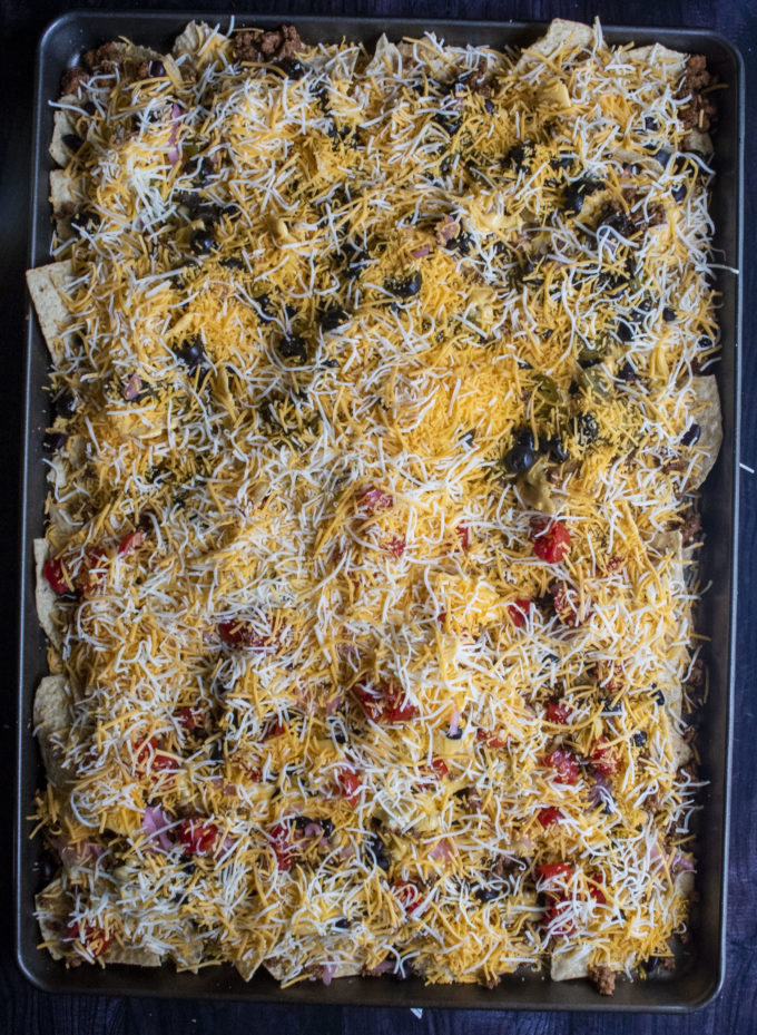 beef nachos on a pan ready to be baked