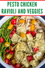 Pesto Chicken Ravioli and Veggies is a quick and easy comfort food meal! This family favorite 30 minute meal is loaded with tender cheese ravioli, chicken bites, asparagus, cherry tomatoes and robust basil pesto. #chickenravioliwithbasilpestoandveggies #pestoravioli #pestoravioliwithchicken #pestoraviolirecipesimple #quickandeasydinnerrecipes #ravioliandchickenrecipe #pestochickenpastarecipes #pestochickenpastaeasy