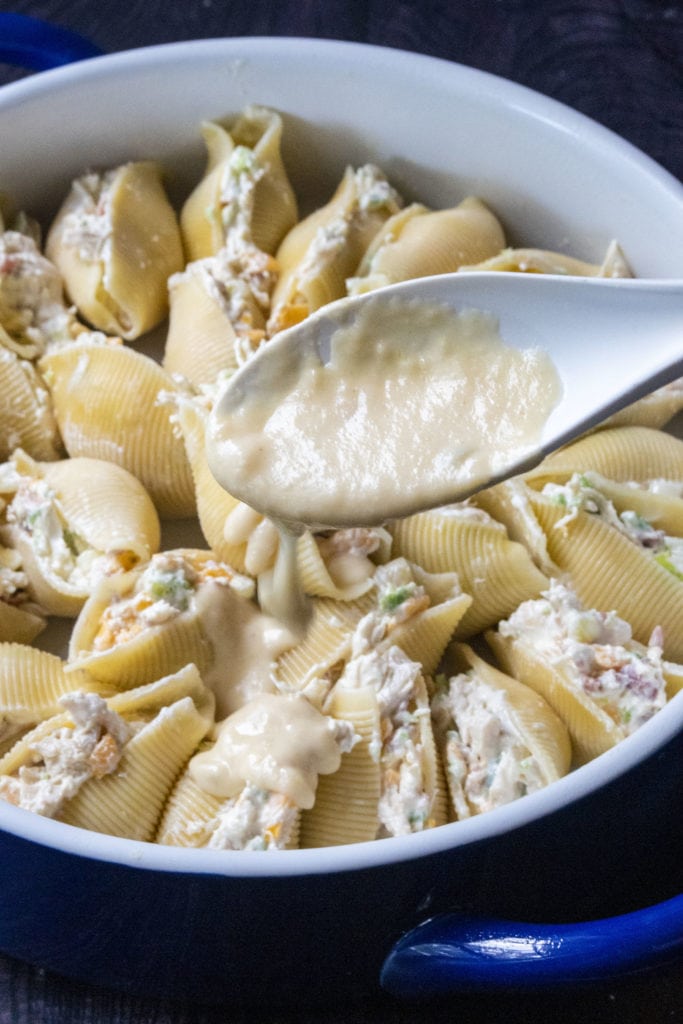 adding cheese sauce to jalapeno popper shells