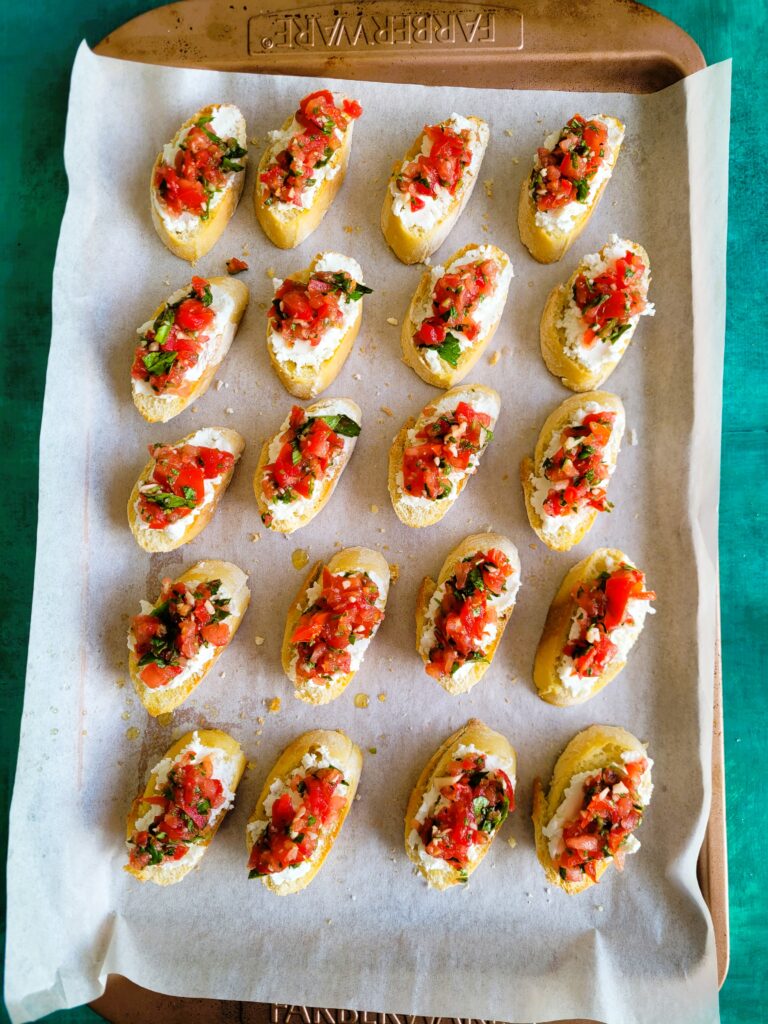 topping goat cheese with tomatos