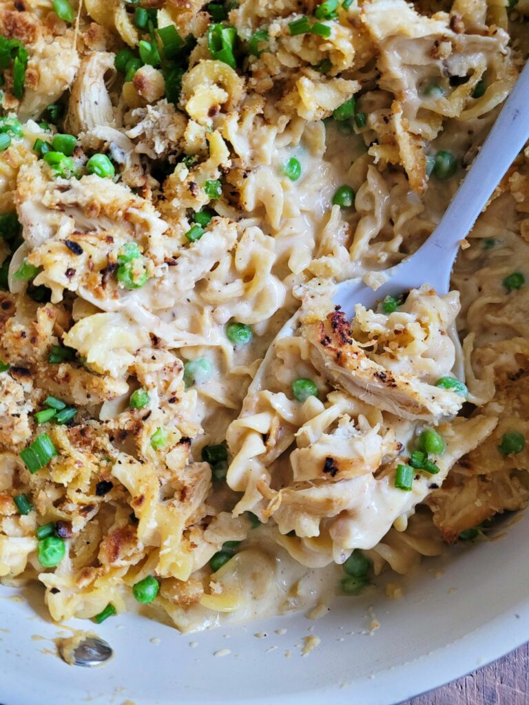 Cheesy Chicken Noodle Casserole is the perfect classic combination of cheesy pasta, seasoned chicken and a Ritz cracker topping. Made from scratch, this old school chicken and egg noodle casserole is an easy weeknight dinner your family will love.