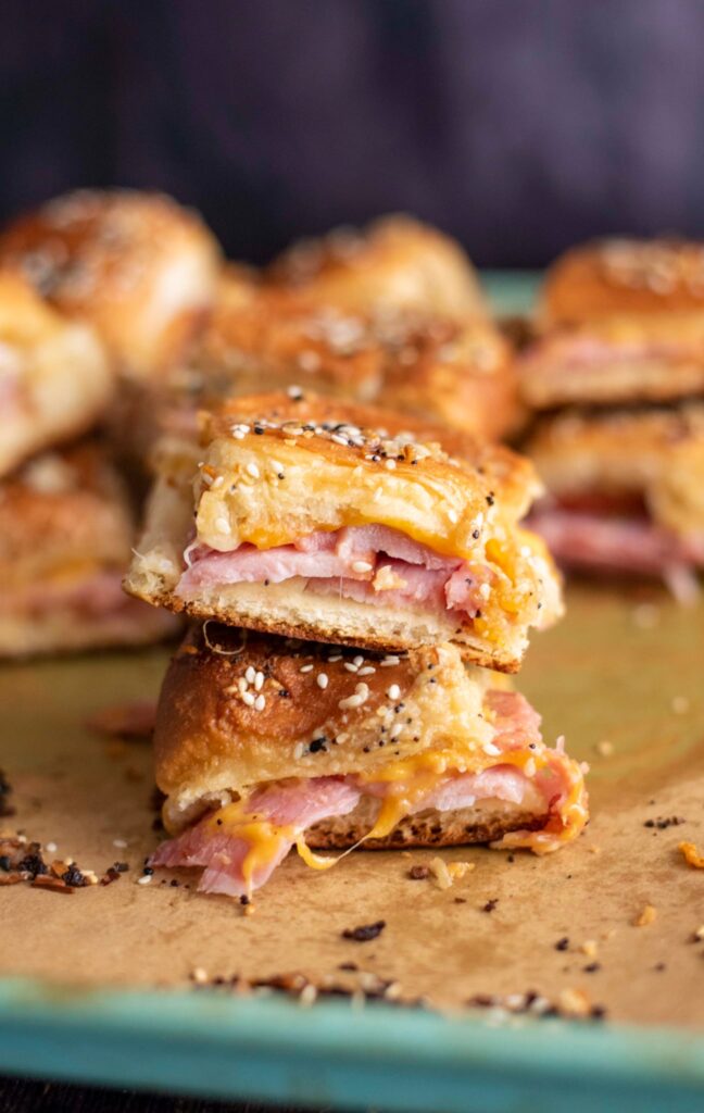 stacked ham and cheese sliders on hawaiian rolls