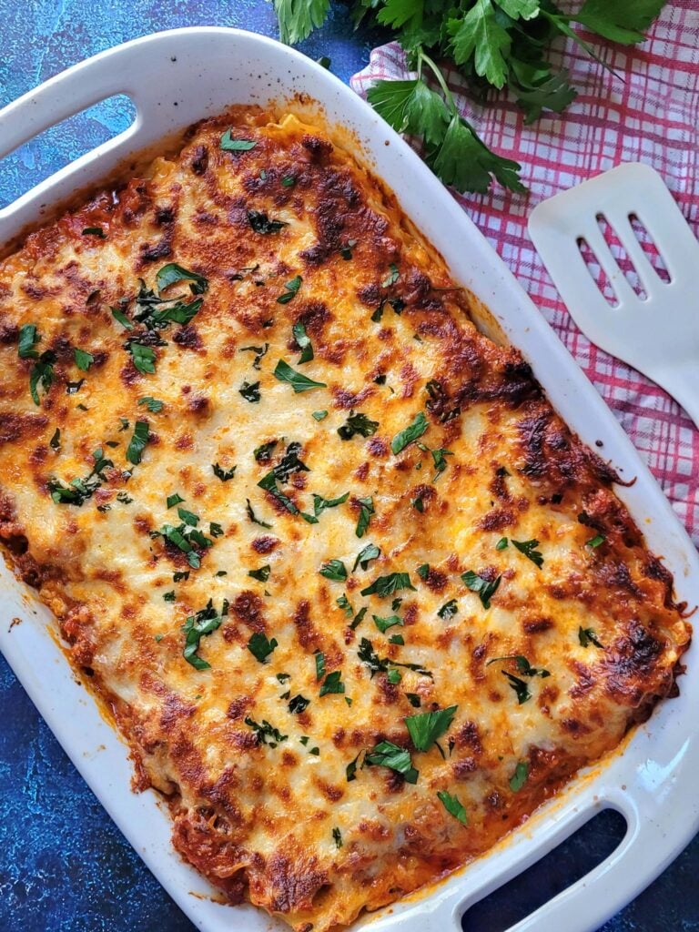 This Easy Homemade Lasagna recipe is a nostalgic, cheesy homemade lasagna recipe with creamy ricotta & hearty meat sauce. Perfect for family dinners, make-ahead meals, and freezer-friendly fun!