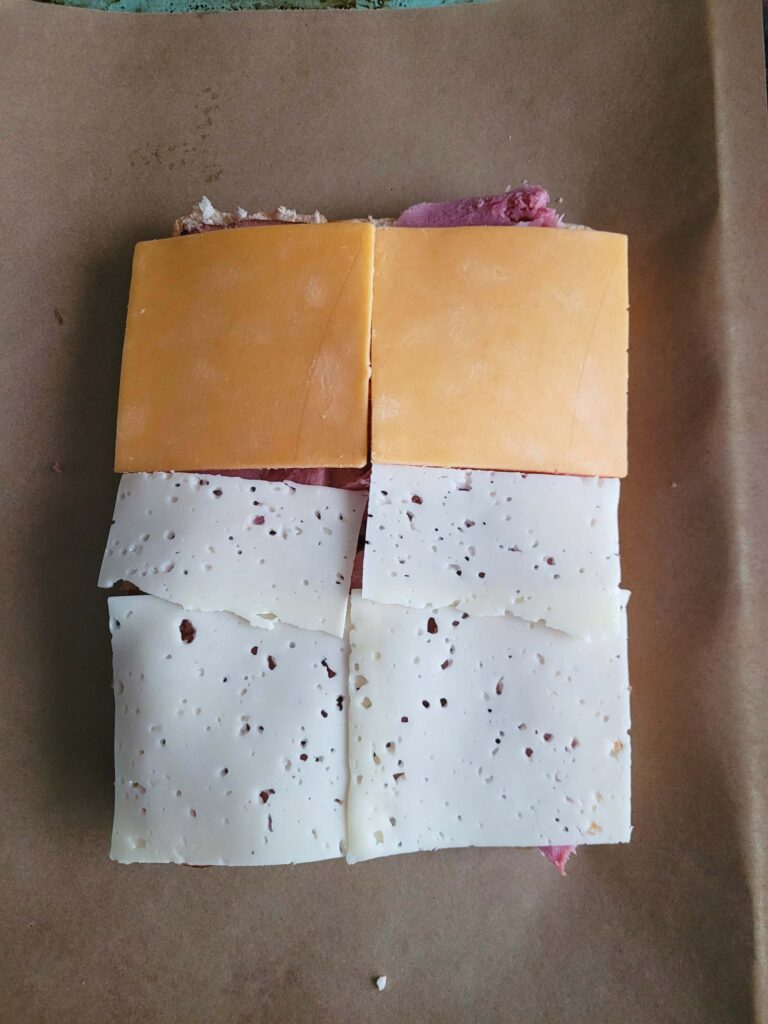 slices of cheese over ham for sliders