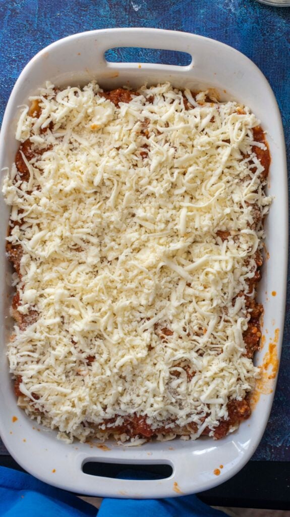 pan of classic lasagna with shredded mozzarella cheese