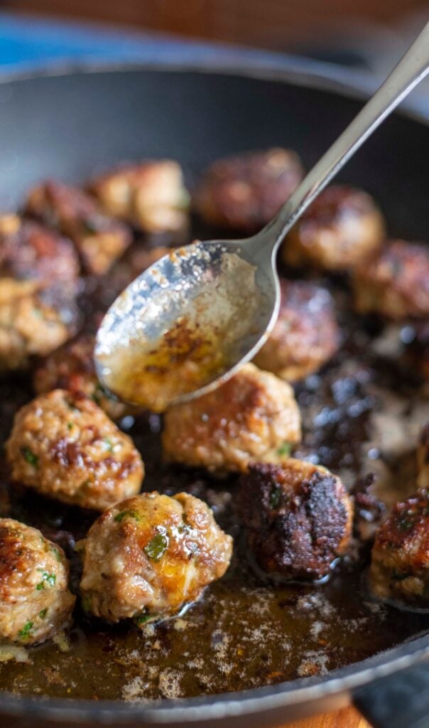 cooking turkey and italian mixed meatballs in a skillet