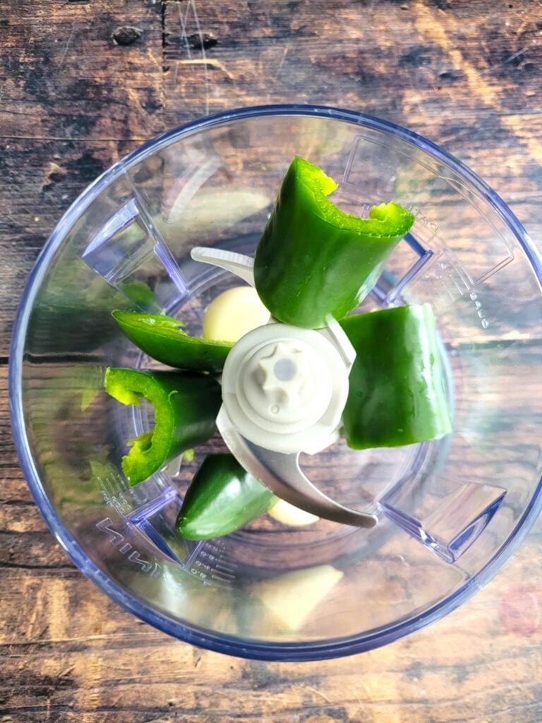 mini food processor stuffed with garlic and jalapeno