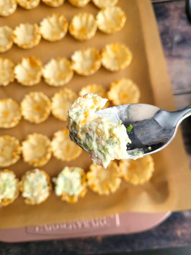 filling the cups with the cheese filling