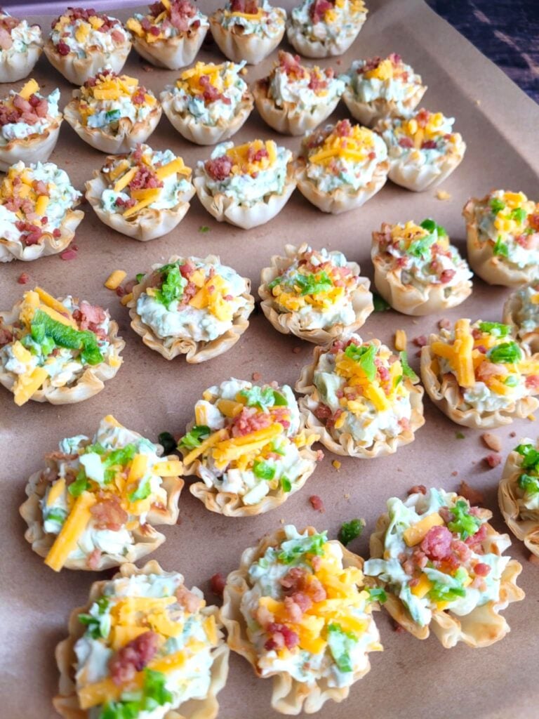 tray of cheese popper bites with and without jalapeno garnish
