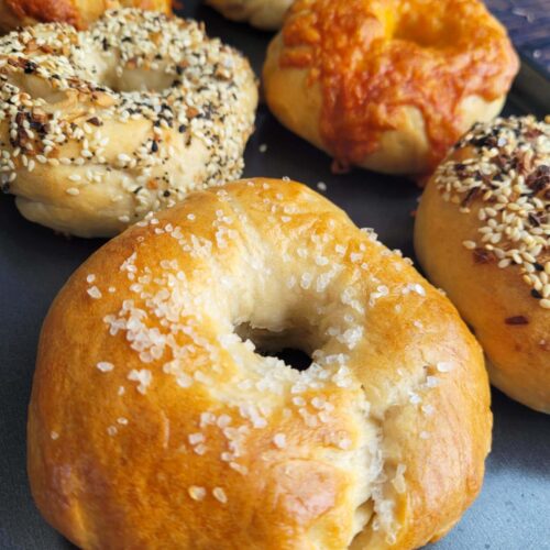 Easy sourdough bagel recipe with chewy crust and tangy flavor! Learn how to make sourdough bagels from scratch with no yeast and basic pantry ingredients.