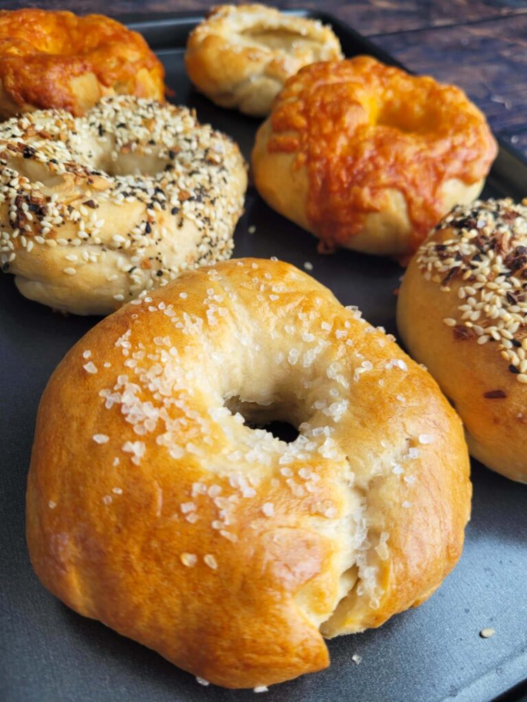 Easy sourdough bagel recipe with chewy crust and tangy flavor! Learn how to make sourdough bagels from scratch with no yeast and basic pantry ingredients.